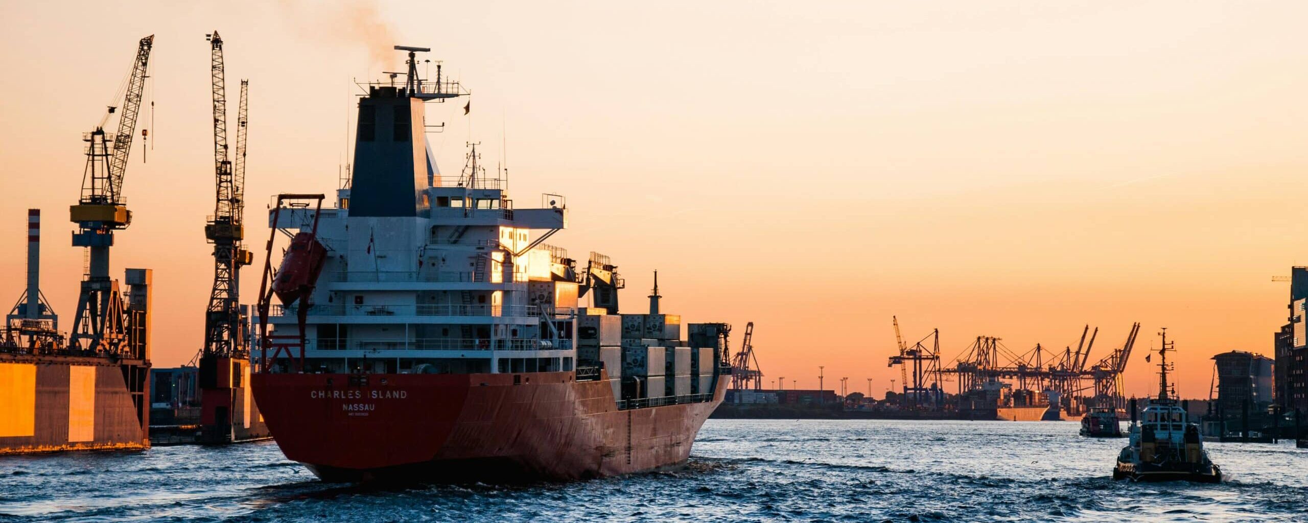 Container ship driving into a harbor.
